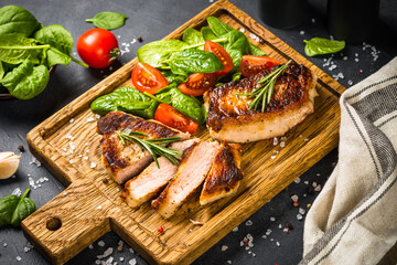 Meat steaks with fresh salad served at wooden served board. Keto diet food. Close up