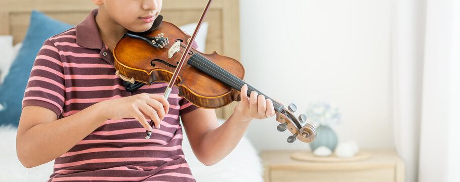 Banner Teenage Boy, Smiling, Playing, Practicing Violin Musical Instrument With Happiness In Bedroom At Cozy Home In Leisure Time, Smiling, Having Copy Space. Education, Lifestyle, Creativity Concept.