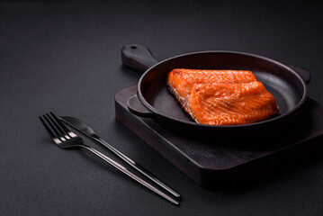 Delicious baked salmon red fish steak with spices and herbs