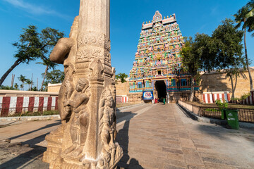 Beautiful carvings on stone pillars outside the gopuram tower of the ancient Hindu temple of...