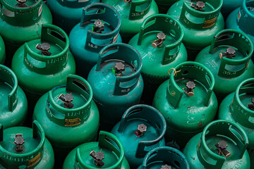 LPG gas green  bottle stack ready for sell, stand in pattern.  Thai language stamp on the bottle...