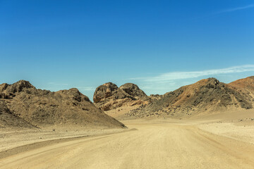 Fototapeta na wymiar sand road through the moon landscape landscape near Swakopmund, Namibia