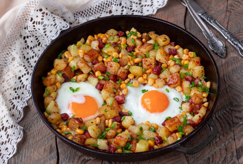 Skillet Potato Hash With Bacon, Corn and Fried Egg. Wooden table, selective focus, horizontal. - obrazy, fototapety, plakaty