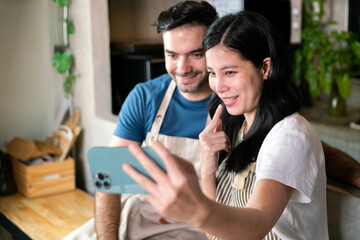 love and romantic couple boyfriend and girlfriend selfie photo with mobile phone together during dinner cook for valentine celebration in kitchen