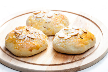 almond buns on wooden board
