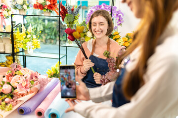 Cauasian Female Owner Of Florists Shop With Laptop Talking On Mobile Phone.Asia woman vlogger influencer or SME owner people smile work on home video camera selfie .