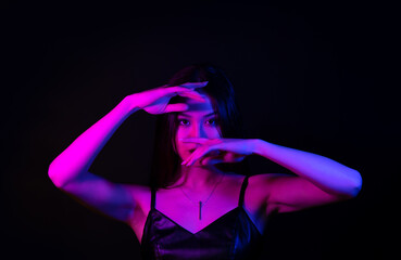 Dancing woman in neon lights. Beautiful brunette woman portrait.