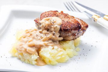 grilled meat with mashed potatoes with onion sauce