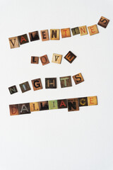 set of words: "valentine, love, nights, dalliance" composed of chipboard tiles with vintage style letters on blank paper