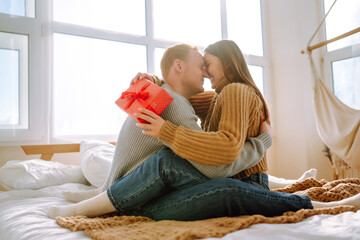 Obraz premium Young couple at home celebrating Valentine's Day. Romantic day together.