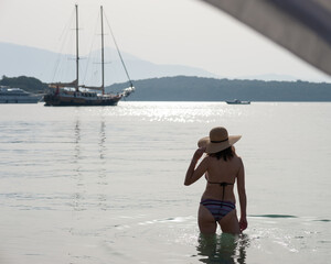 A young woman enjoys her vacation in Nydri, Greece