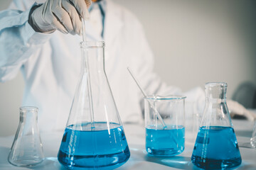 Scientist experimental in laboratory with test tube and beaker for medical research