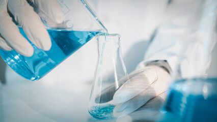 Scientist experimental in laboratory with test tube and beaker for medical research