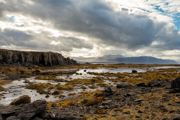 Beautiful coastline during low tide with rocks and clouds and scenic view in the westfjords, Iceland, Europe