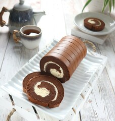 Chocolate roll cake served on a white tray