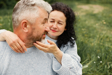 Fototapeta premium Senior couple sitting in a park and looking on each other