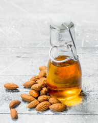 Almond oil in a glass bottle .