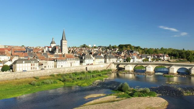 The Charite sur Loire bridge and a dune over the Loire in Europe, France, Burgundy, Nievre, in summer, on a sunny day.
