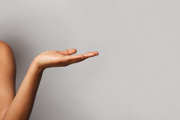 Empty female hand. Open palm hand on gray banner background