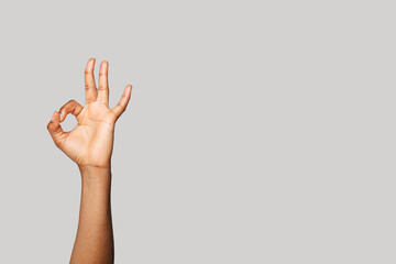 Hand with okay sign gesture on white banner background