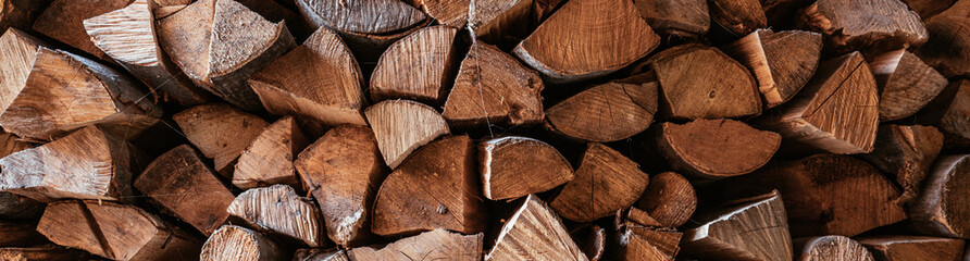 Horizontal image Chopped firewood is stacked in a big pile