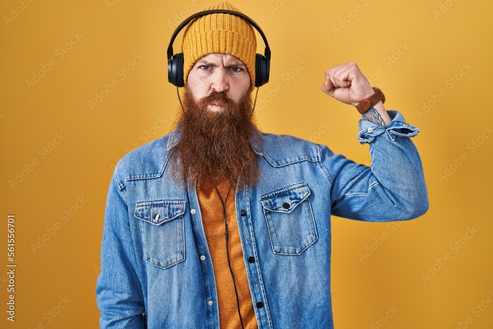 Sticker caucasian man with long beard listening to music using headphones strong person showing arm muscle, 