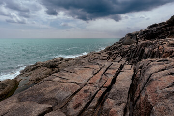 Seascape with granite rocks on the sea shore under overcast sky, Samui, Thailand