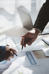 Businessman is reviewing monthly sales documents for analysis and marketing plans for more sales...
