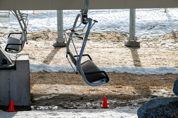 Empty ski chairlifts because the snow is melting