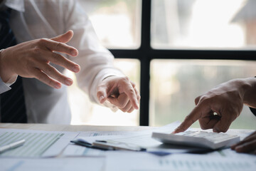 Atmosphere of a startup company meeting, business people are meeting together to summarize and plan investment finances, they are the founders of the company. Business administration concept.