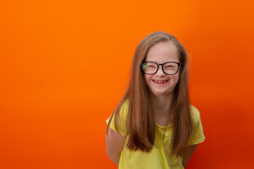 Happy girl with Down syndrome having fun and laughing in the studio