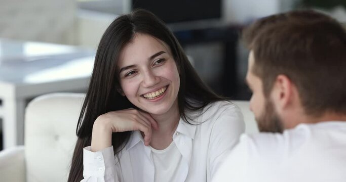 Young beautiful brunette girl talk to guy during dating in cafe, close up view. Couple spend weekend together meet in cafeteria, smile enjoy pleasant conversation, share news. Relationship, friendship