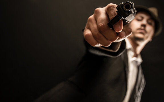 old school gangster with gun in hand