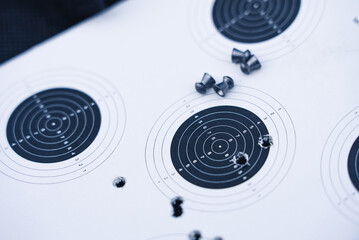 Airgun pellets on a paper shooting target. High quality photo