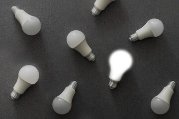 LED light bulbs on gray color background. Flat lay. Pattern.