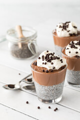 Chocolate chia pudding cups topped with chocolate covered quinoa puffs.