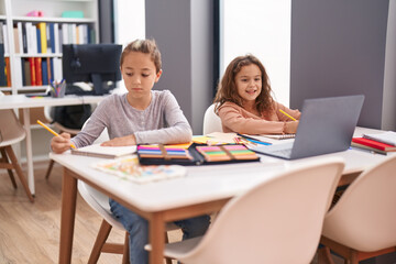 Fototapeta na wymiar Two kids students using computer studying at classroom