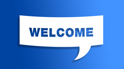 Speech bubble sign with the word welcome in front of a blue colored wall