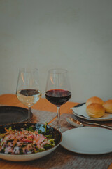 Italian restaurant table with dinner of pasta salad and a glass of wine