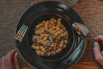 Italian restaurant table with dinner of pasta salad and a glass of wine