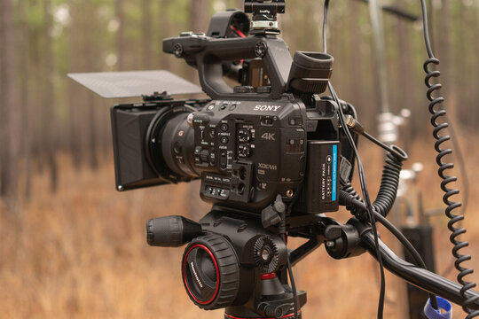 Wakefield, Virginia US - January 12, 2023: Sony FS5 outfitted with matte box and filter is shooting a 12 bit 4K ProRes RAW codec to an external recorder while filming on location in a pine savannah