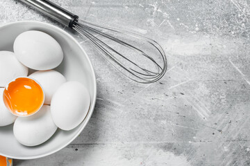 Eggs in bowl with whisk.