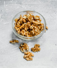 Walnuts in a glass bowl .