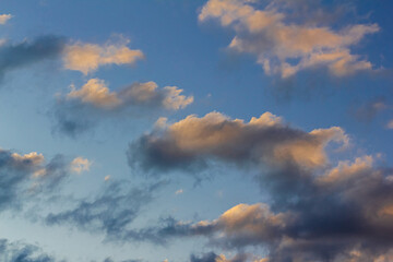The rays of the setting sun glide over a dark overcast cloud. Overcast weather
