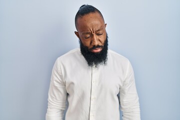 African american man standing over blue background depressed and worry for distress, crying angry and afraid. sad expression.
