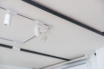 white led spotlight standing in white background. the system runs suspended from the ceiling on the...