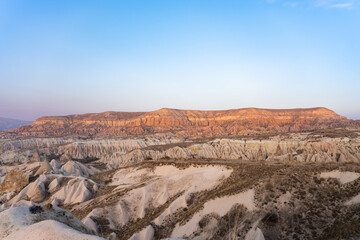 Fototapeta premium Stunning Cappadocia landscape with the rock formations during a beautiful sunset. Red & Rose Valley, Cappadocia, central Anatolia, Turkey
