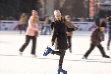 Happy smile woman roller skating Ice roller rink winter sunset.