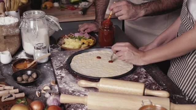 Homemade pizza decorating on the table, fast food cooking in the kitchen at home, Food Fottage Clip.