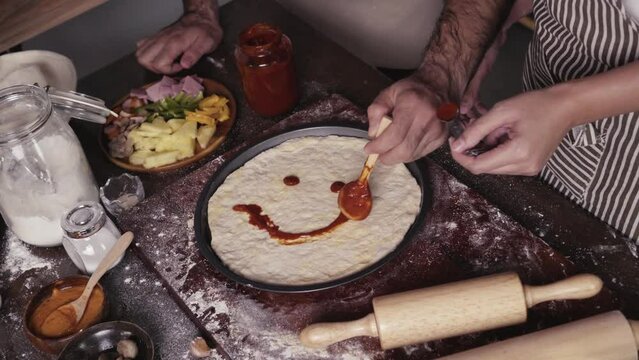 Homemade pizza decorating on the table, fast food cooking in the kitchen at home, Food Fottage Clip.